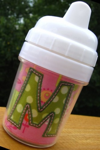 Picture of the finished insert inside the small sippy cup with the letter "M" from our #382 Funky Applique Font set [NOT included].
