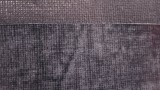 This picture shows black fabric with Fuse-Adhere applied. The top portion is the black fabric only and the bottom portion is the fuse-adhere.