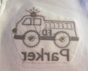 After application - nicely protected/covered stitches on the back of a t-shirt - very silky, smooth texture for infant and toddlers skin.