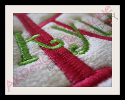 Close-up of stitched example on a towel.
